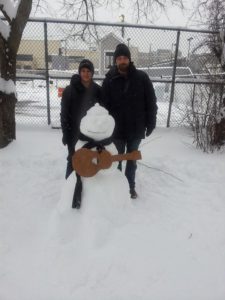 Brad Rau and Paola Molina Chew building a guitar playing snowman in Boston. 